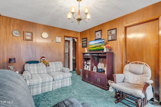 carpeted living room featuring wood walls and an inviting chandelier