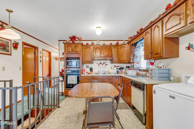 kitchen with stainless steel microwave, dishwasher, sink, oven, and decorative light fixtures