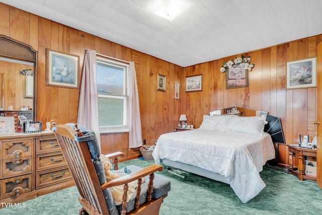 carpeted bedroom featuring wood walls