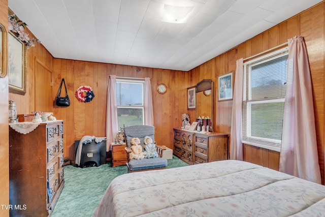 bedroom with wood walls and carpet floors