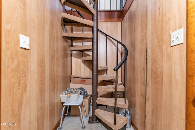 staircase with wood walls