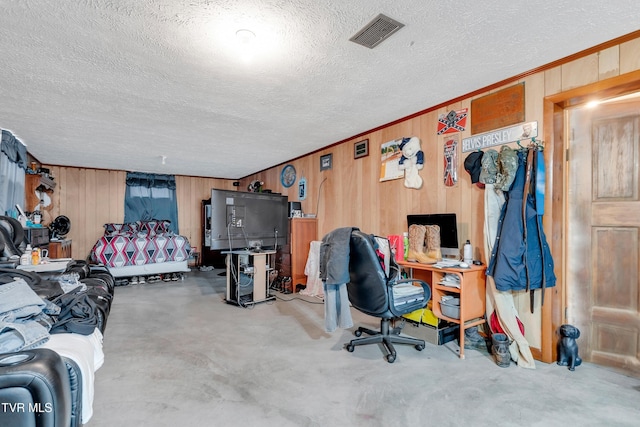 bedroom with wood walls and a textured ceiling