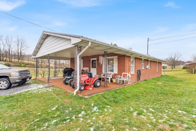 view of front of house with a front yard and a carport