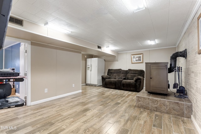 interior space with light wood-style floors, visible vents, and ornamental molding