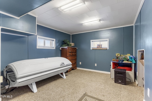 carpeted bedroom featuring baseboards and crown molding