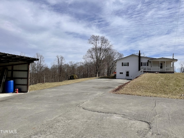 exterior space featuring a porch and driveway