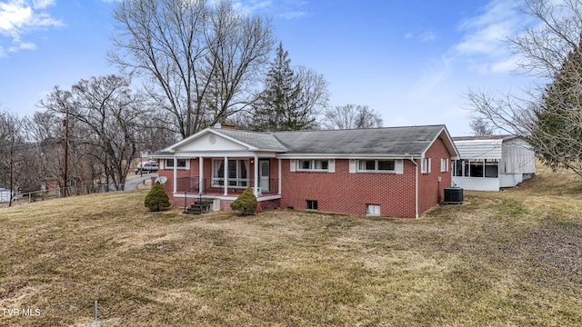 ranch-style home with a porch, a front yard, and central air condition unit