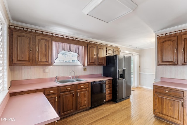 kitchen with crown molding, sink, light hardwood / wood-style flooring, and black appliances