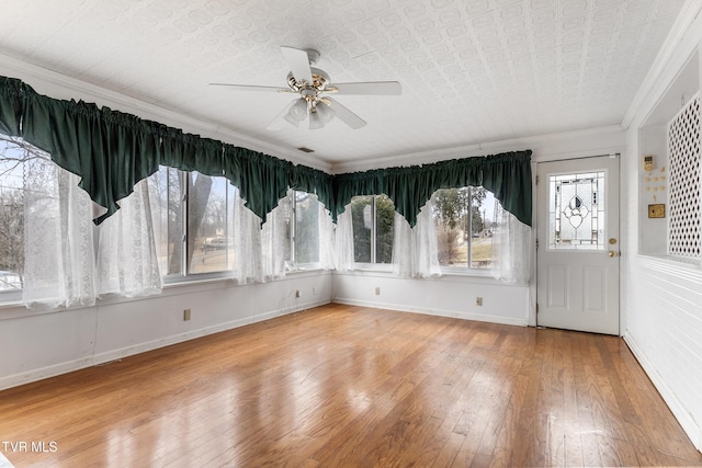 interior space featuring ornamental molding, hardwood / wood-style floors, and ceiling fan