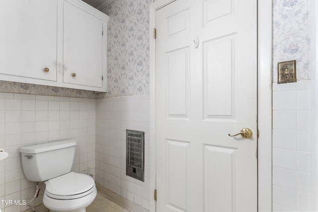 bathroom with heating unit and toilet