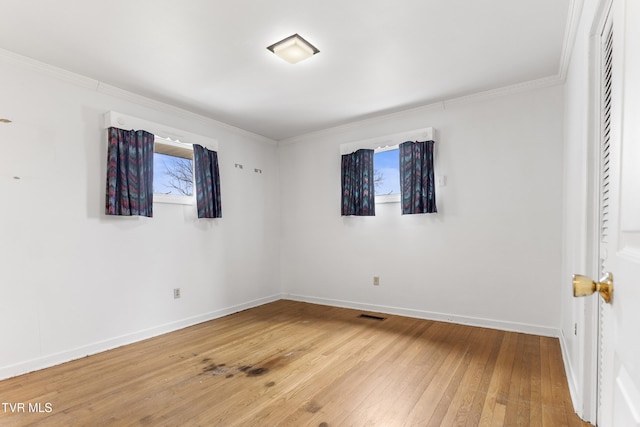 unfurnished room with hardwood / wood-style flooring and crown molding