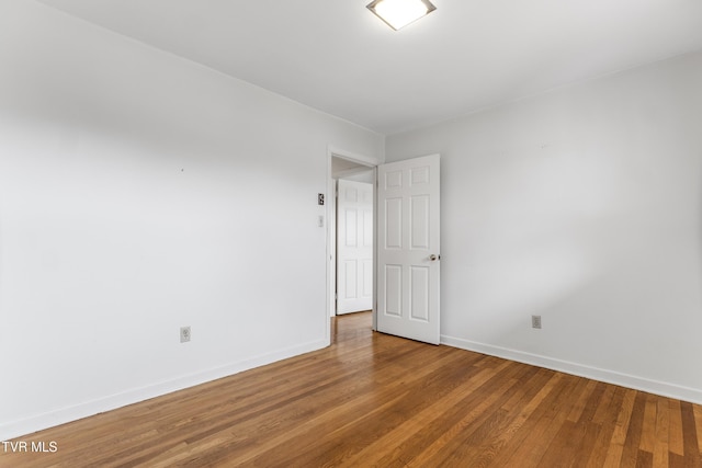 spare room with hardwood / wood-style floors