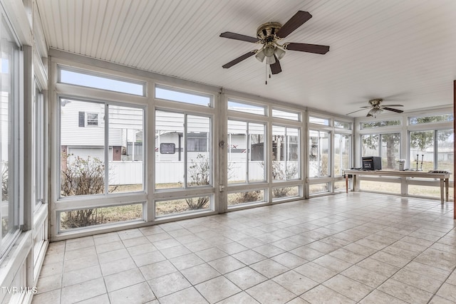 unfurnished sunroom with ceiling fan