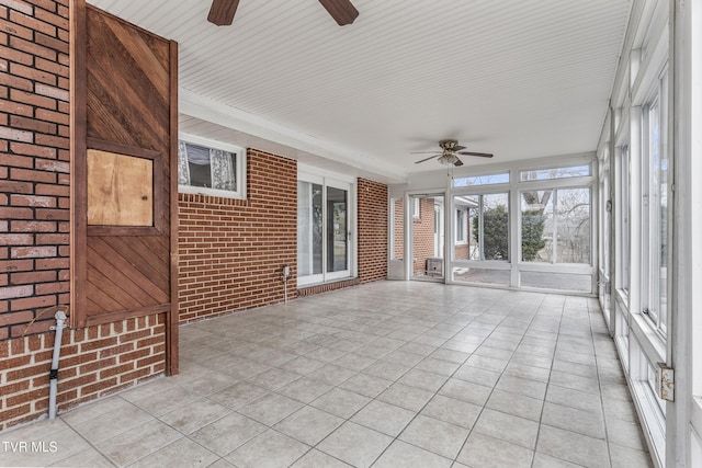 unfurnished sunroom with ceiling fan