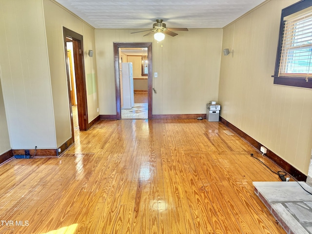 empty room featuring light wood-type flooring and ceiling fan