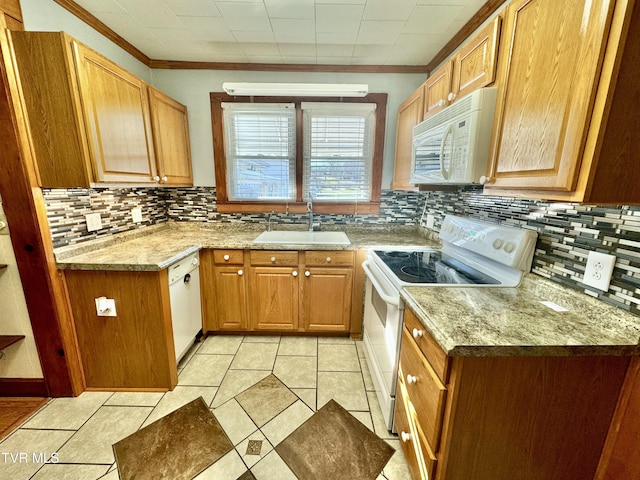 kitchen with decorative backsplash, sink, white appliances, and ornamental molding