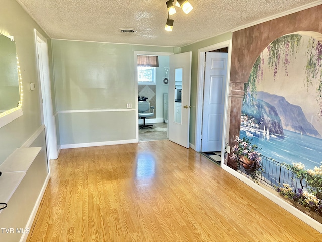 empty room featuring light hardwood / wood-style floors and a textured ceiling