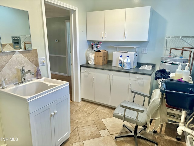 kitchen featuring white cabinets and sink