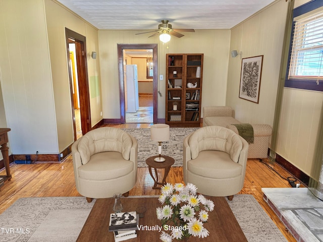 living room with ceiling fan and light hardwood / wood-style flooring