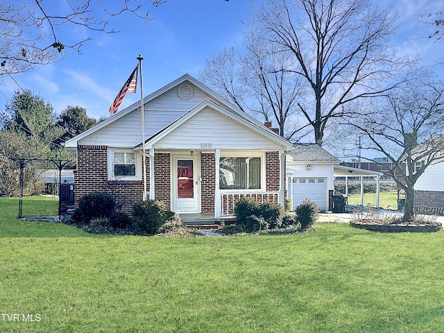 view of front of home with a front yard and a garage