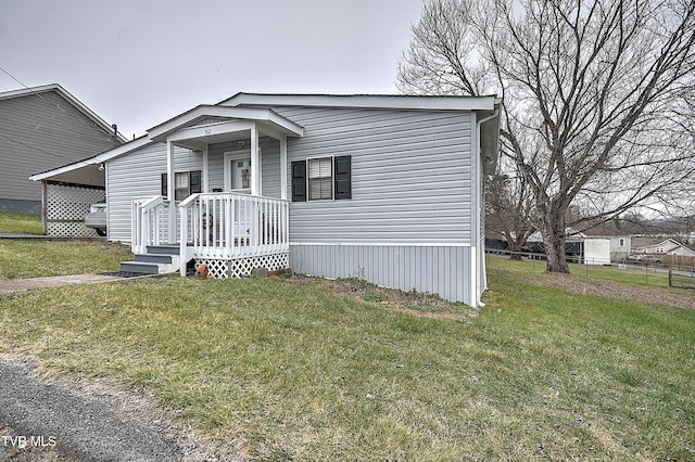 view of front of property with a carport and a front lawn