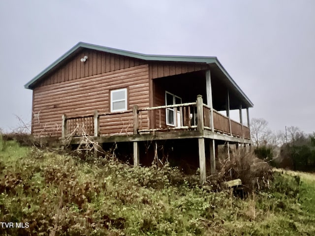 view of side of home with a wooden deck