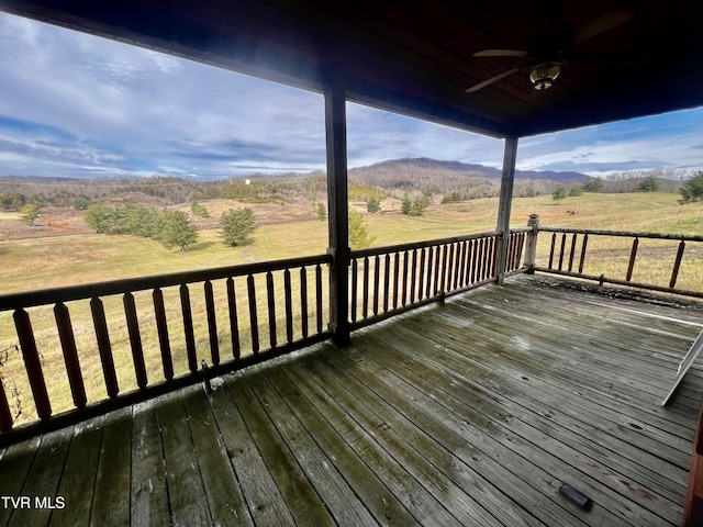 deck with a lawn, ceiling fan, and a rural view