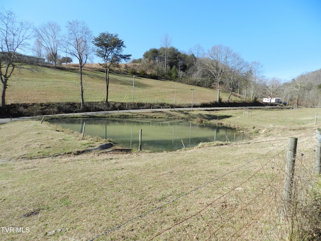 view of yard with a water view and a rural view