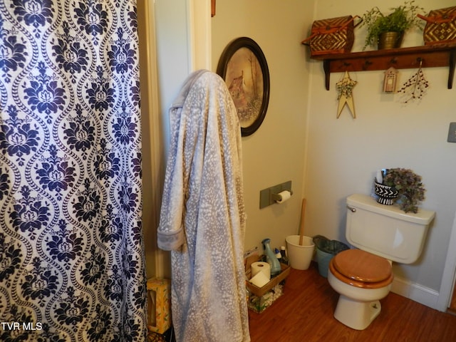 bathroom with toilet and wood-type flooring