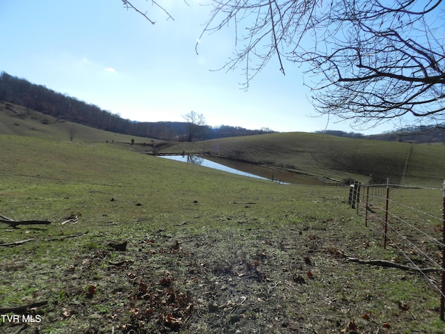 view of yard featuring a rural view and a water view