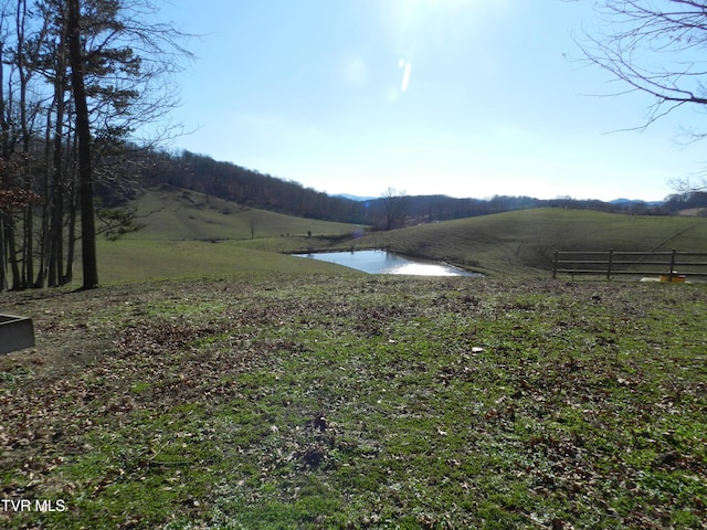 view of yard featuring a water view and a rural view