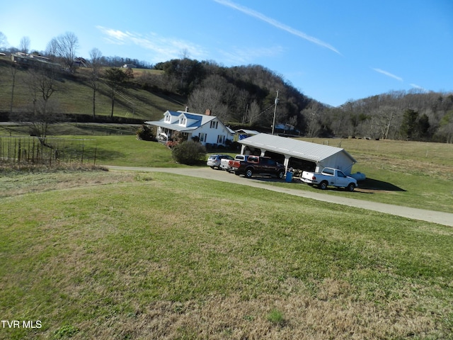 view of yard with a rural view and a carport