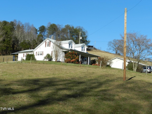 view of property exterior with a yard