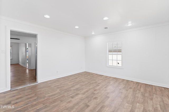 unfurnished room featuring hardwood / wood-style floors and ornamental molding