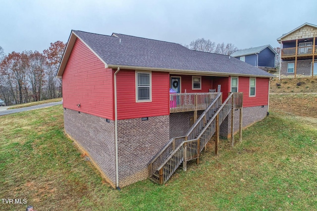 back of house featuring a wooden deck and a lawn