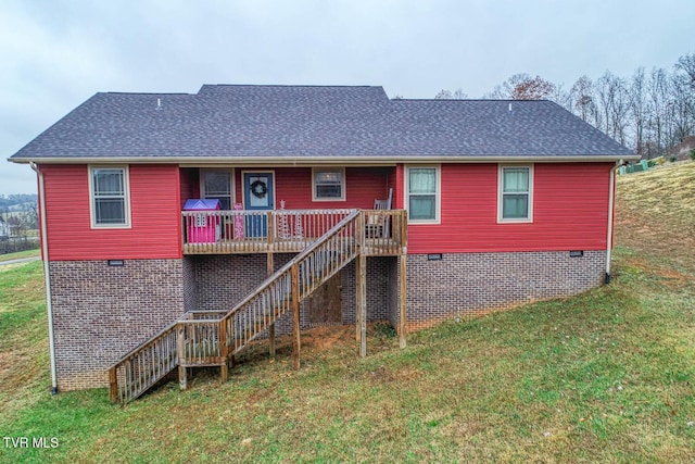 rear view of property with a lawn and a deck