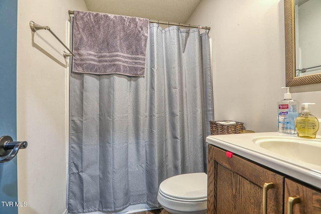 bathroom with vanity, a shower with shower curtain, and toilet