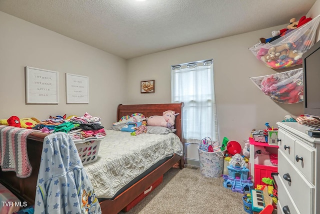 bedroom featuring light colored carpet and a textured ceiling