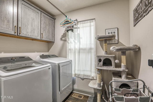 laundry area featuring cabinets and washing machine and dryer