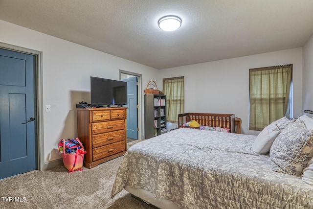 carpeted bedroom featuring a textured ceiling