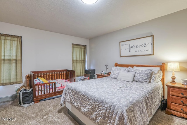 bedroom featuring carpet floors and a textured ceiling