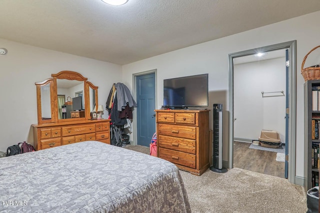 carpeted bedroom featuring a textured ceiling