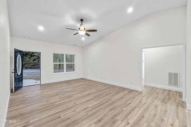 unfurnished room with ceiling fan, light hardwood / wood-style floors, and lofted ceiling