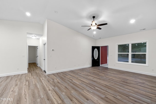 interior space featuring ceiling fan, light wood-type flooring, and lofted ceiling