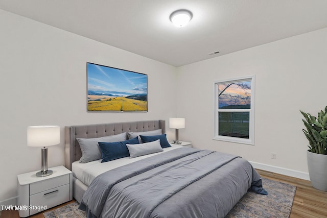 bedroom with wood-type flooring