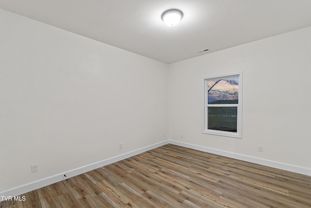 empty room featuring hardwood / wood-style flooring