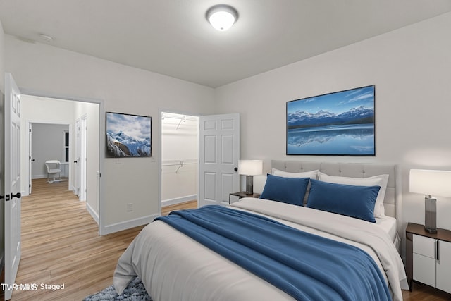 bedroom with hardwood / wood-style flooring and a closet