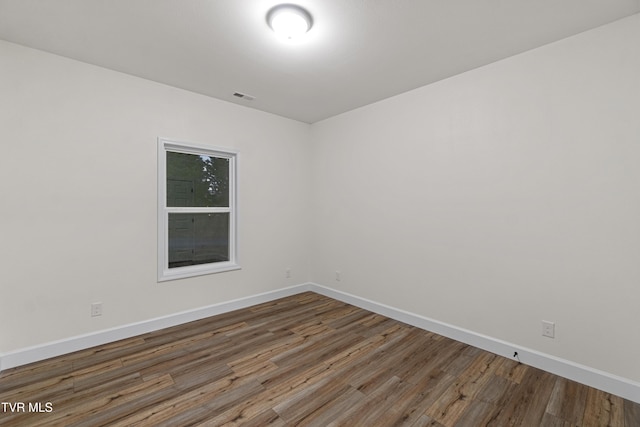 spare room featuring wood-type flooring