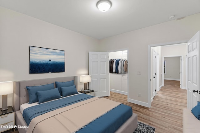 bedroom with a closet and light hardwood / wood-style flooring