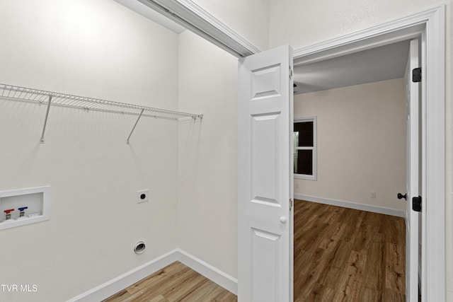 laundry area featuring wood-type flooring, hookup for a washing machine, and electric dryer hookup